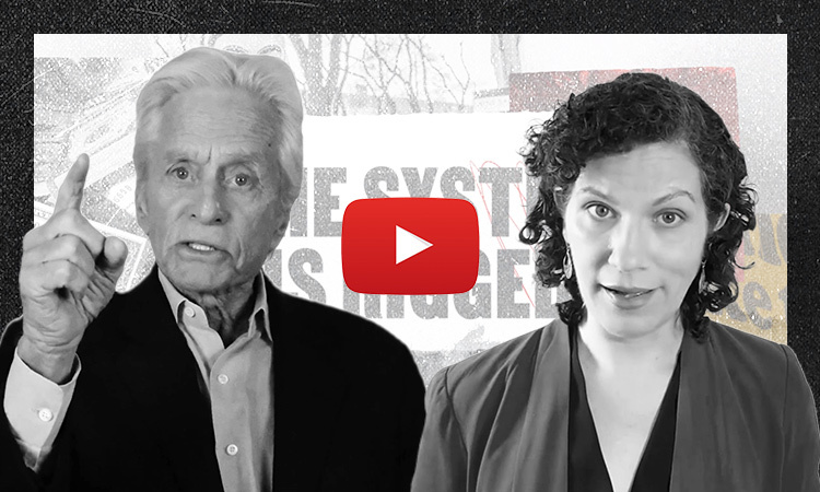 Michael Douglas and Maria McFarland Sanchez-Moreno staring directly into the camera, looking serious